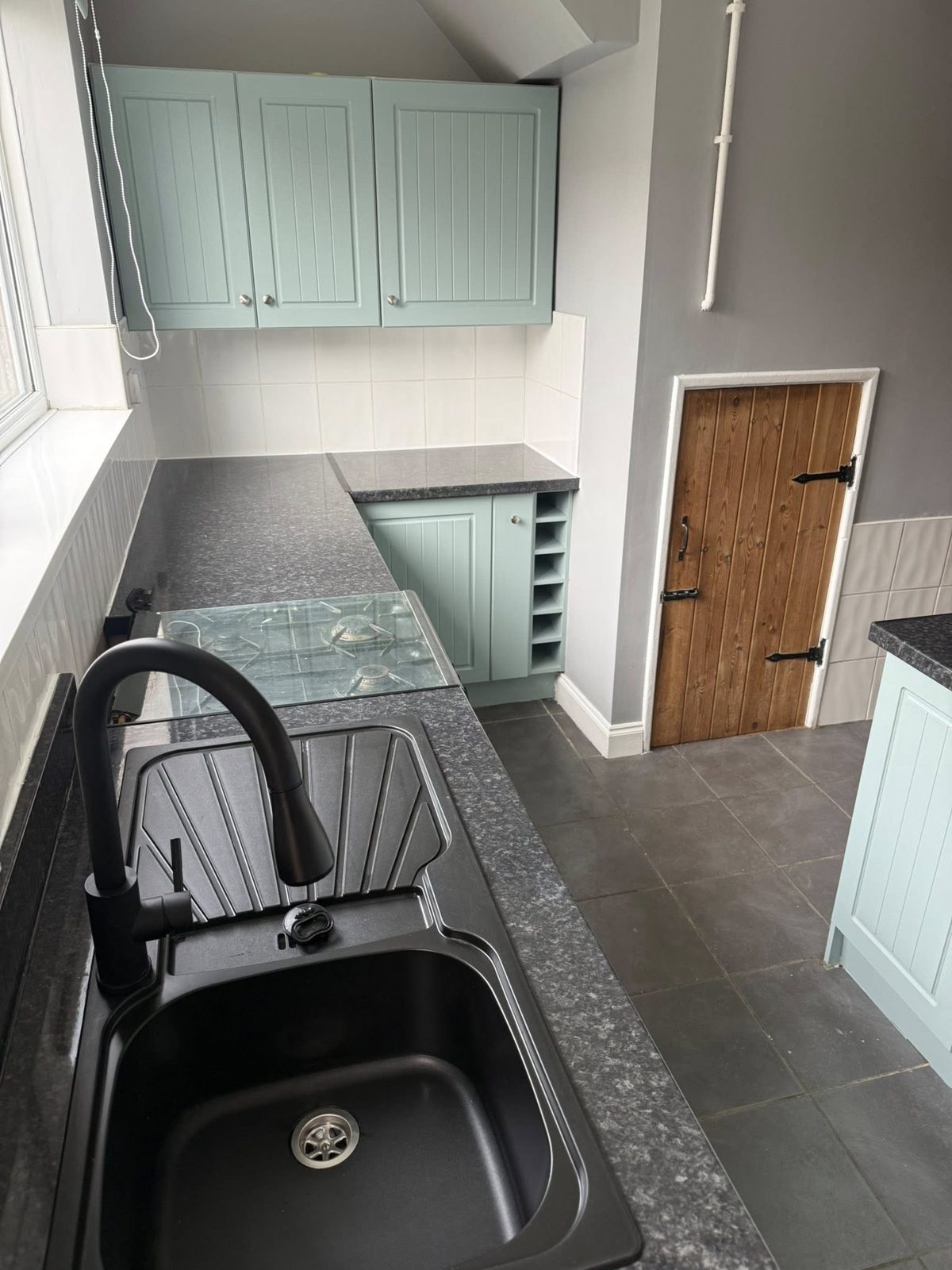Refreshed kitchen with painted units, new worktop, sink and tap