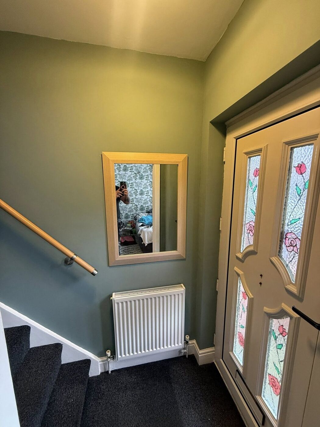 Freshly decorated hallway with new radiator and wall mirror
